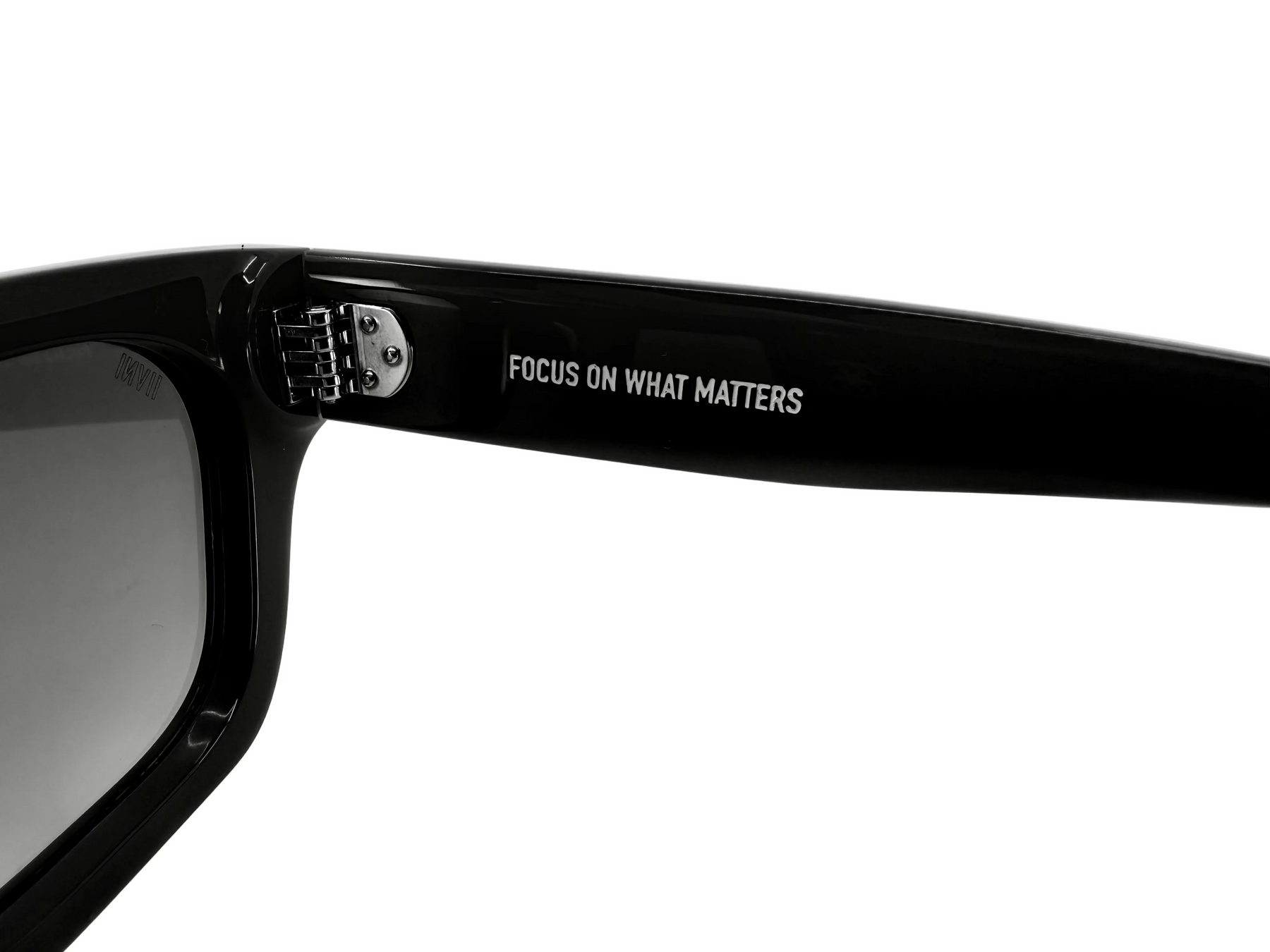 Black sunglasses with 'FOCUS ON WHAT MATTERS' text on a white background